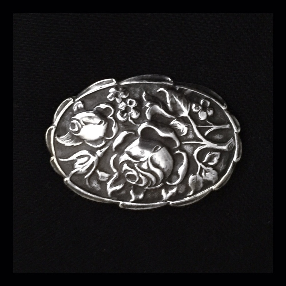Antique silver repousse brooch